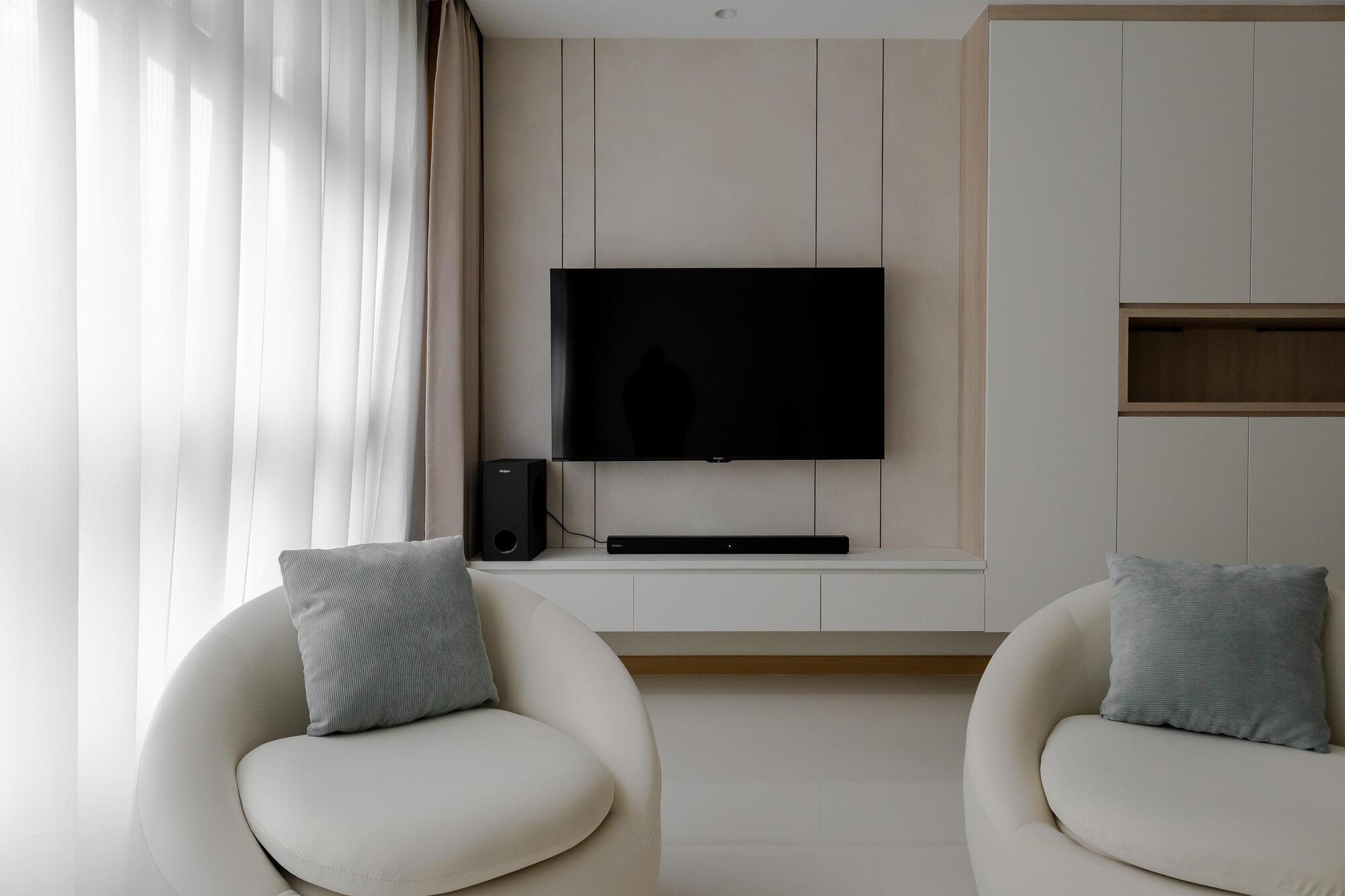A warm, minimal living room designed by Porterbox Studio in Singapore